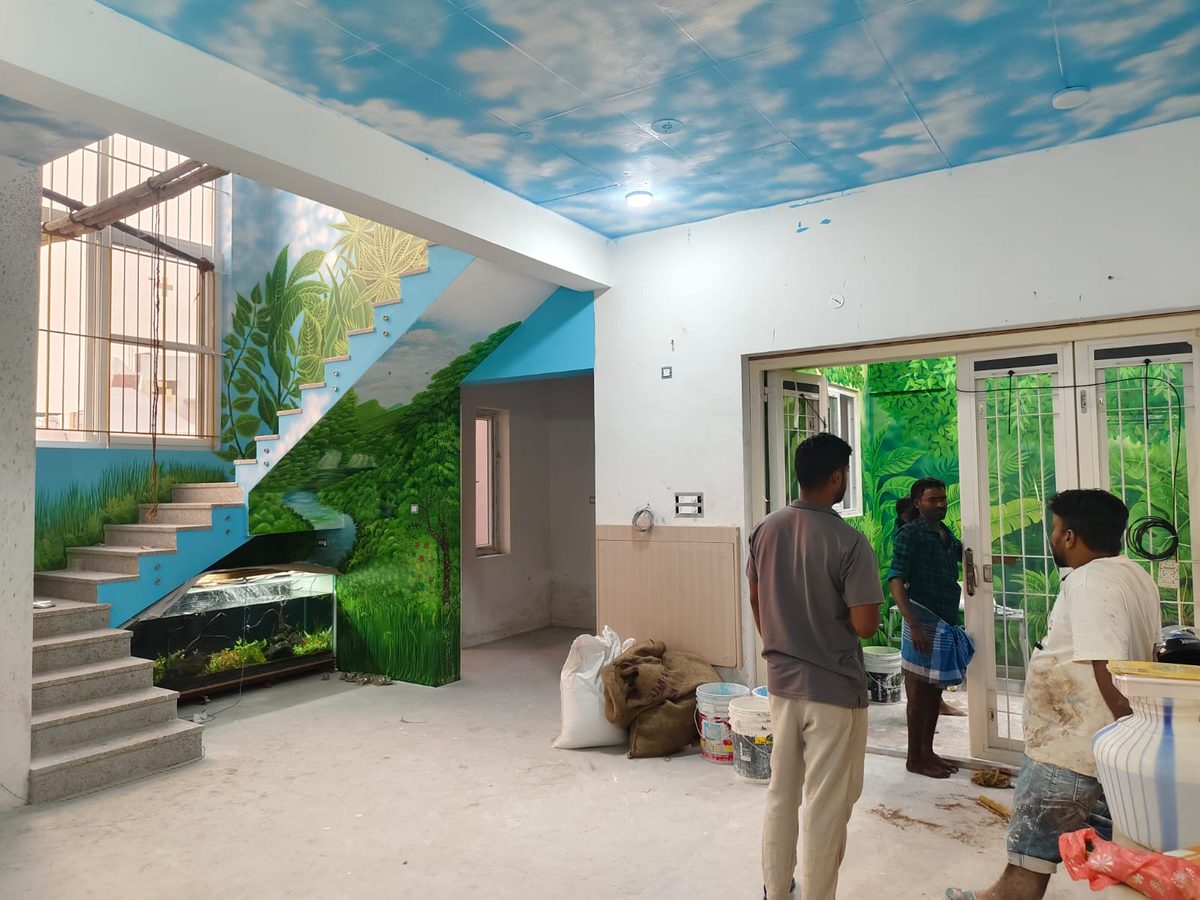 Staircase wall mural with painted sky ceiling and green jungle scene