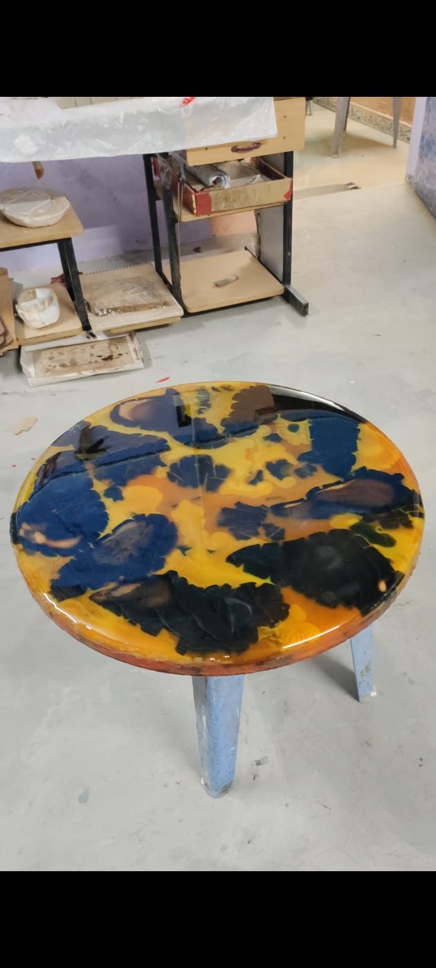 Round side stool with a blue, black and gold splash-pattern epoxy resin top
