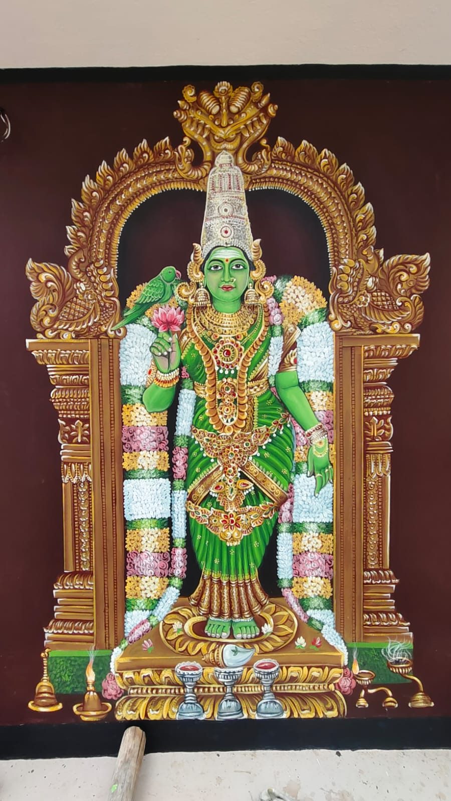 Traditional painting of a goddess within a golden temple arch